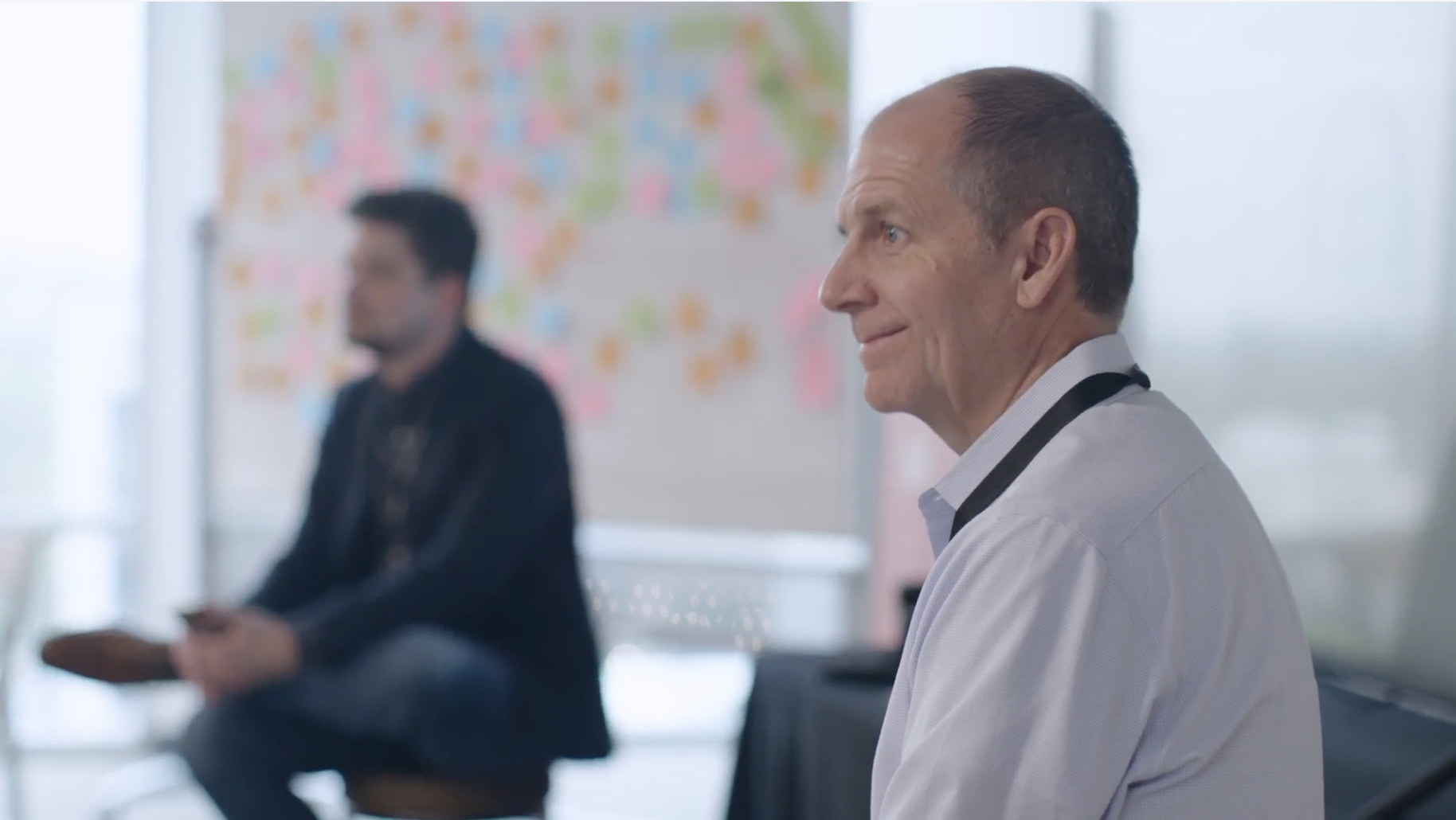 Image of a client talking in fron a crowd