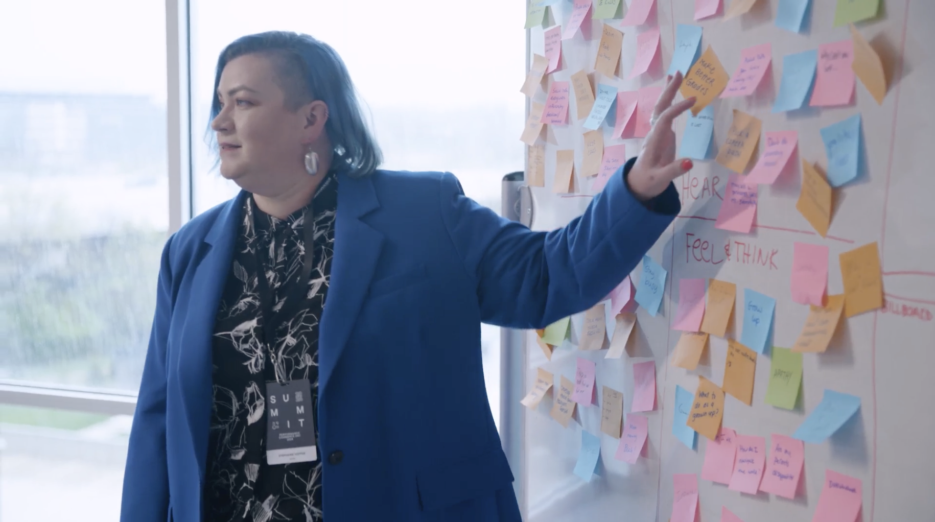 Image of a person point to the post-it note wall